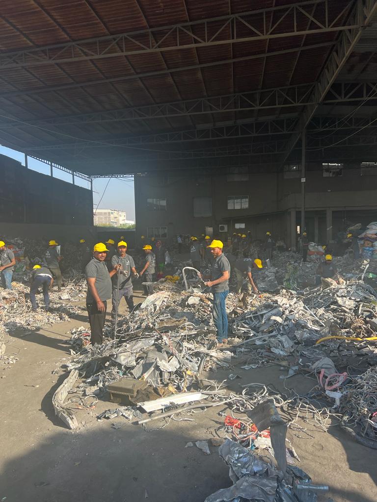 Workers sorting scrap at the yard
